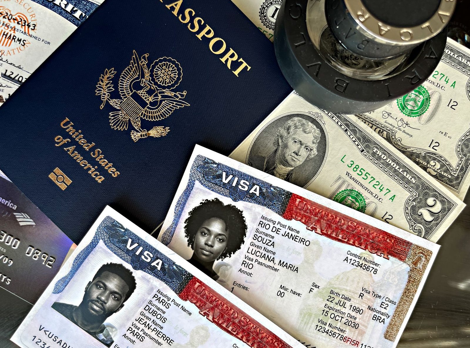 A close-up of a US passport, visa documents, currency, and entry stamps spread across a table.