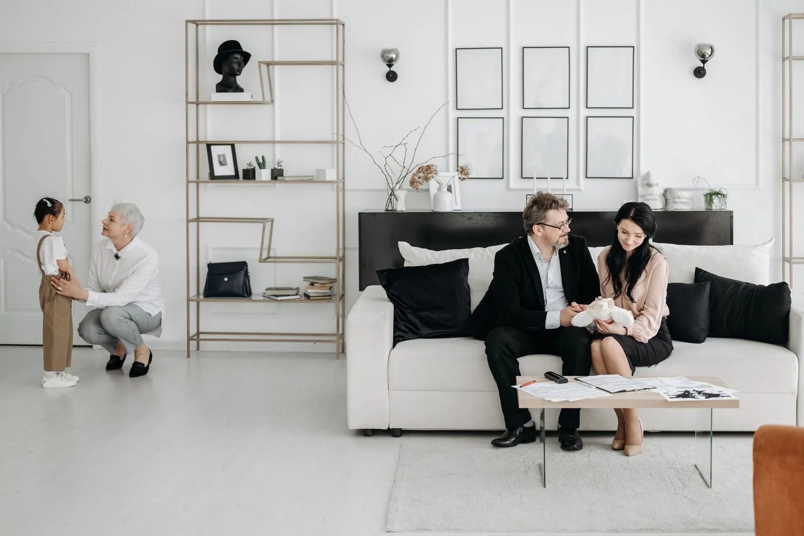 A family relaxes together in a bright, modern living room, showing warmth and care.