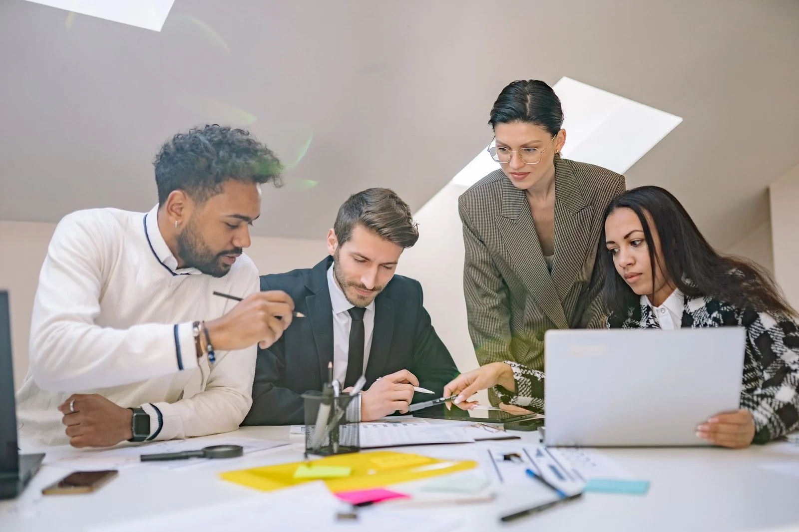 Professionals gathered around a table in a modern office, collaboratively planning business strategy.