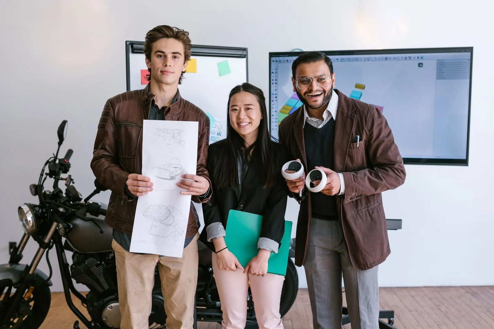 Diverse young entrepreneurs present a new product prototype together in a modern office.