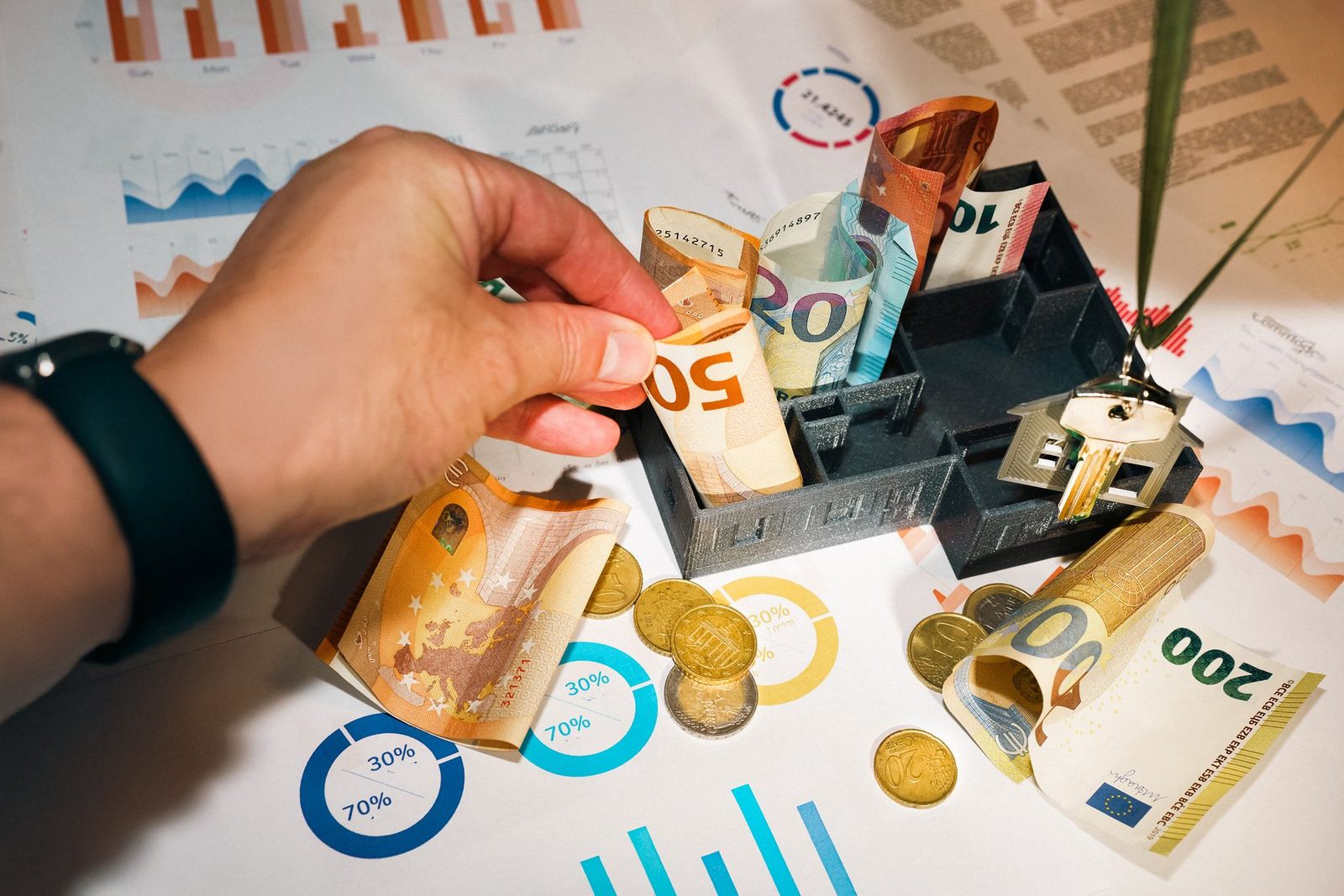 Euro currency and financial charts representing insurance cost analysis and budgeting.