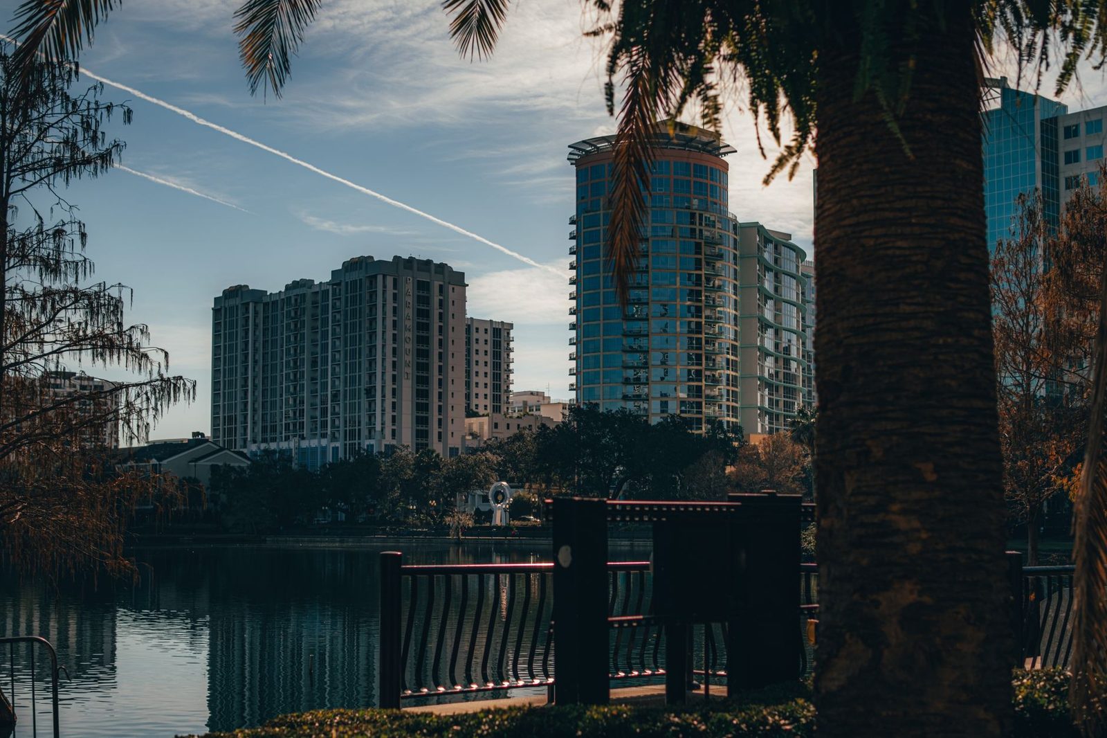 Orlando skyline reflecting on a calm lake with trees, representing affordable family protection.