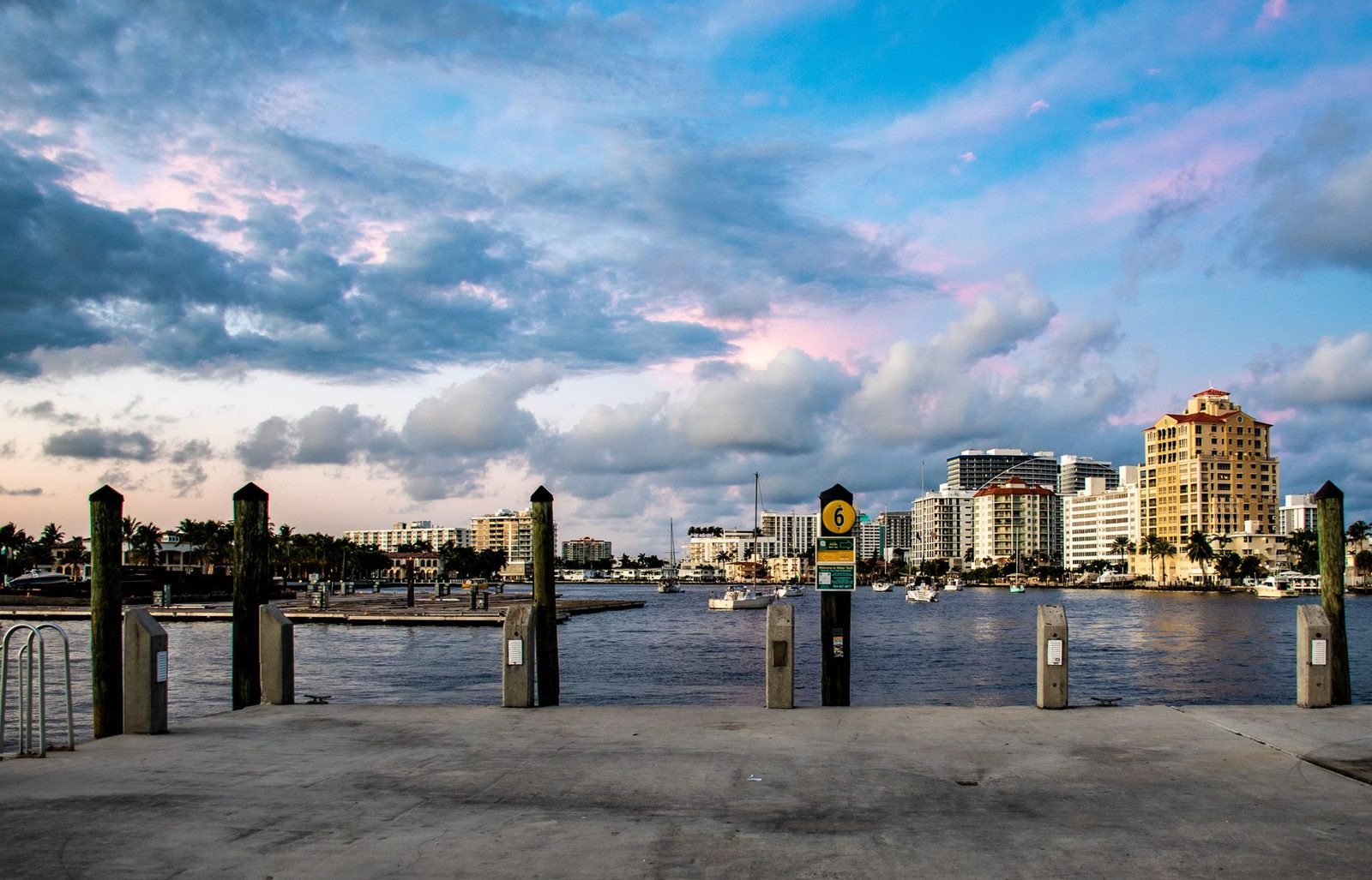 Waterfront city skyline at sunset with boats, representing West Palm Beach.